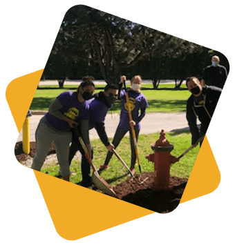 Teenagers digging around a fire hydrant